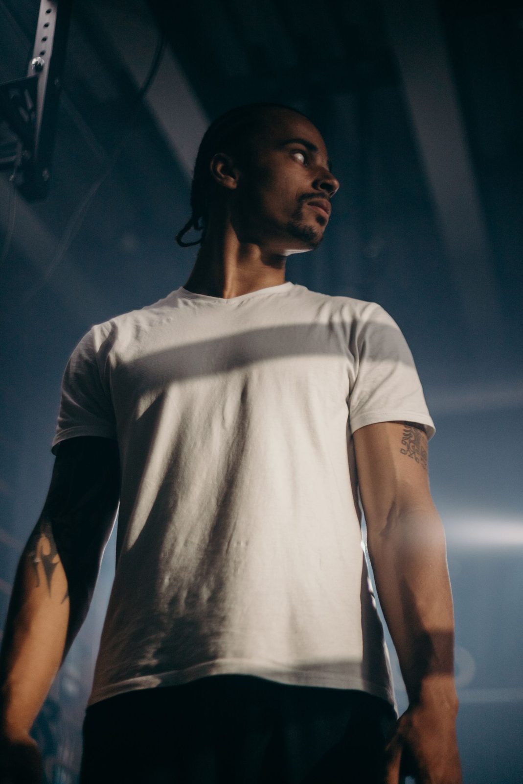 Plain white training shirt with no branding, shown in low light