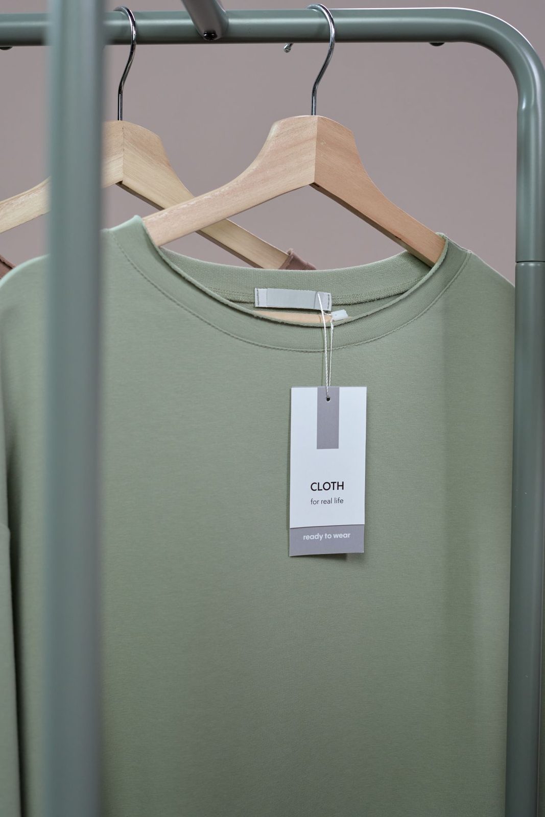 Plain sweatshirt on a hanger with a blank hangtag attached