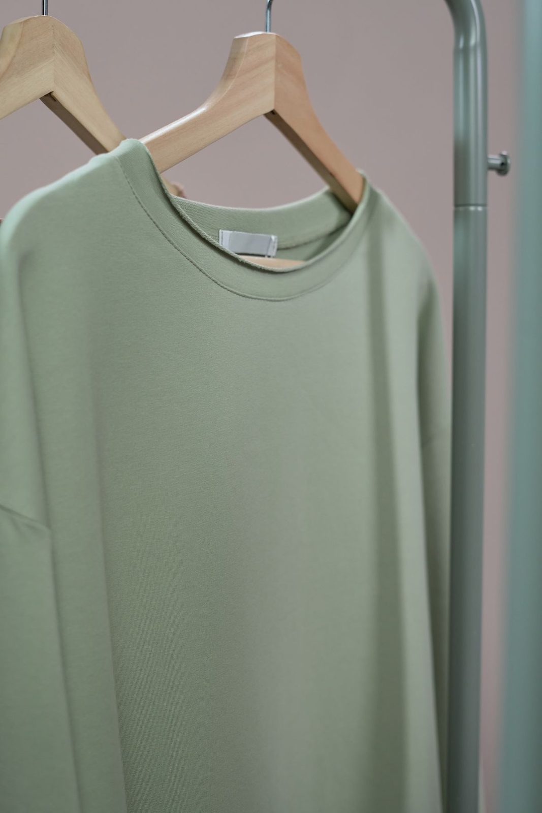 Plain sweatshirt on a hanger showing the inside neckline