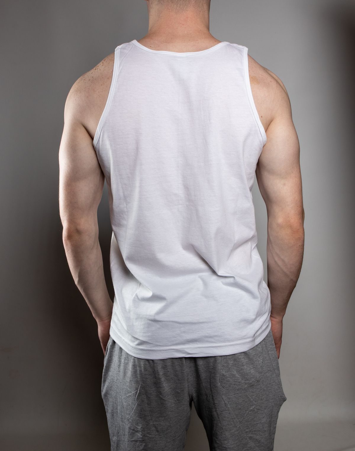 Plain white sleeveless athletic top with no branding