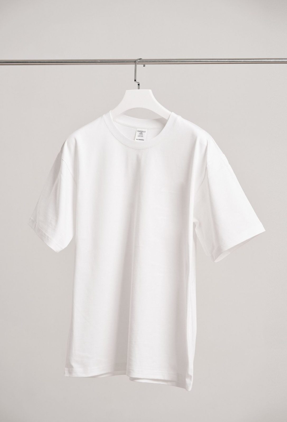 Blank white shirt on a hanger, prepared for screen printing