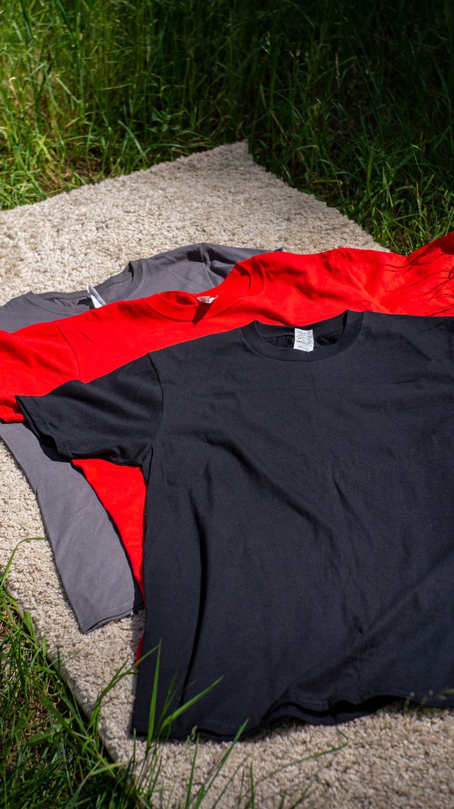 Blank shirts in several colors laid out flat