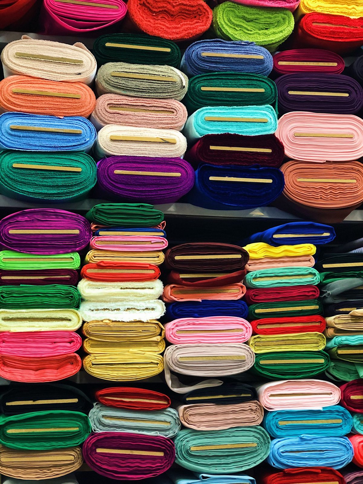 Shelves of fabric rolls in a range of colors