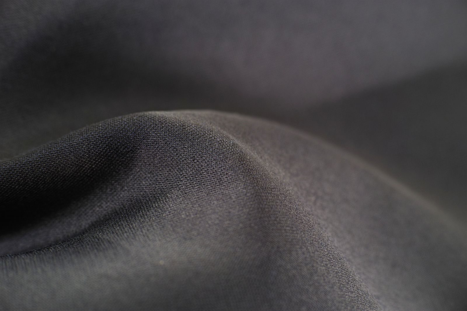 Close-up of smooth charcoal four-way stretch fabric